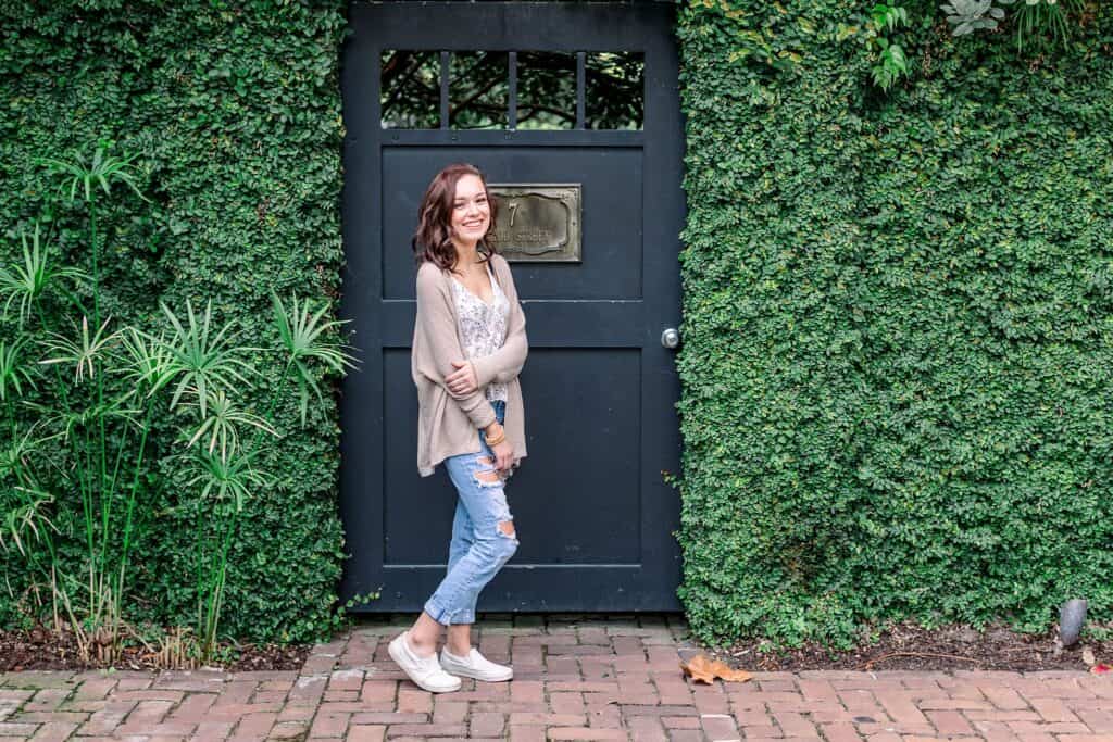 girls standing in front of black door surrounded by ivy by Charleston SC Senior Photographer