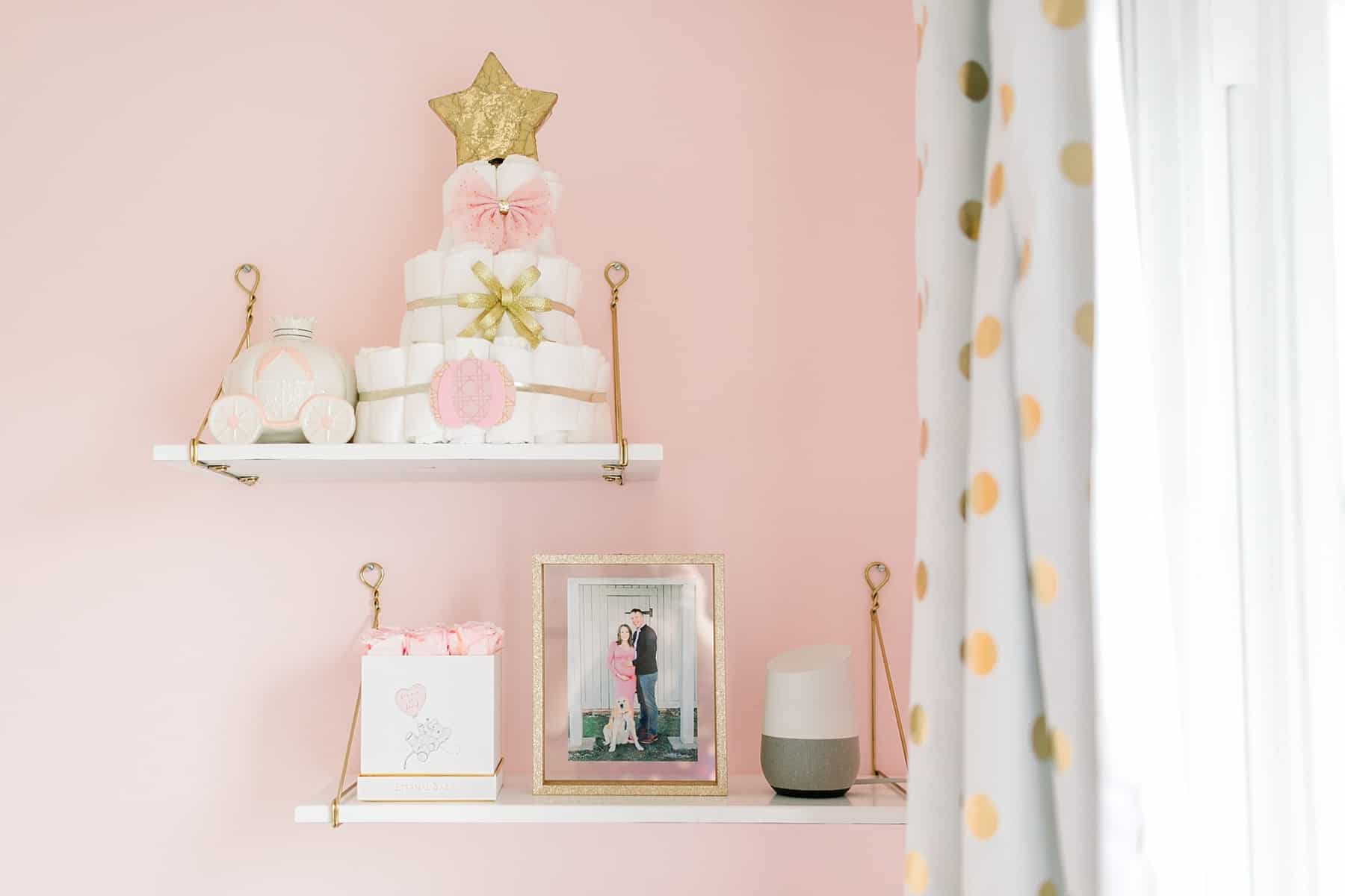 Pink and gold diaper cake on white and gold shelves in Pink & Gold Kate Spade Inspired Nursery