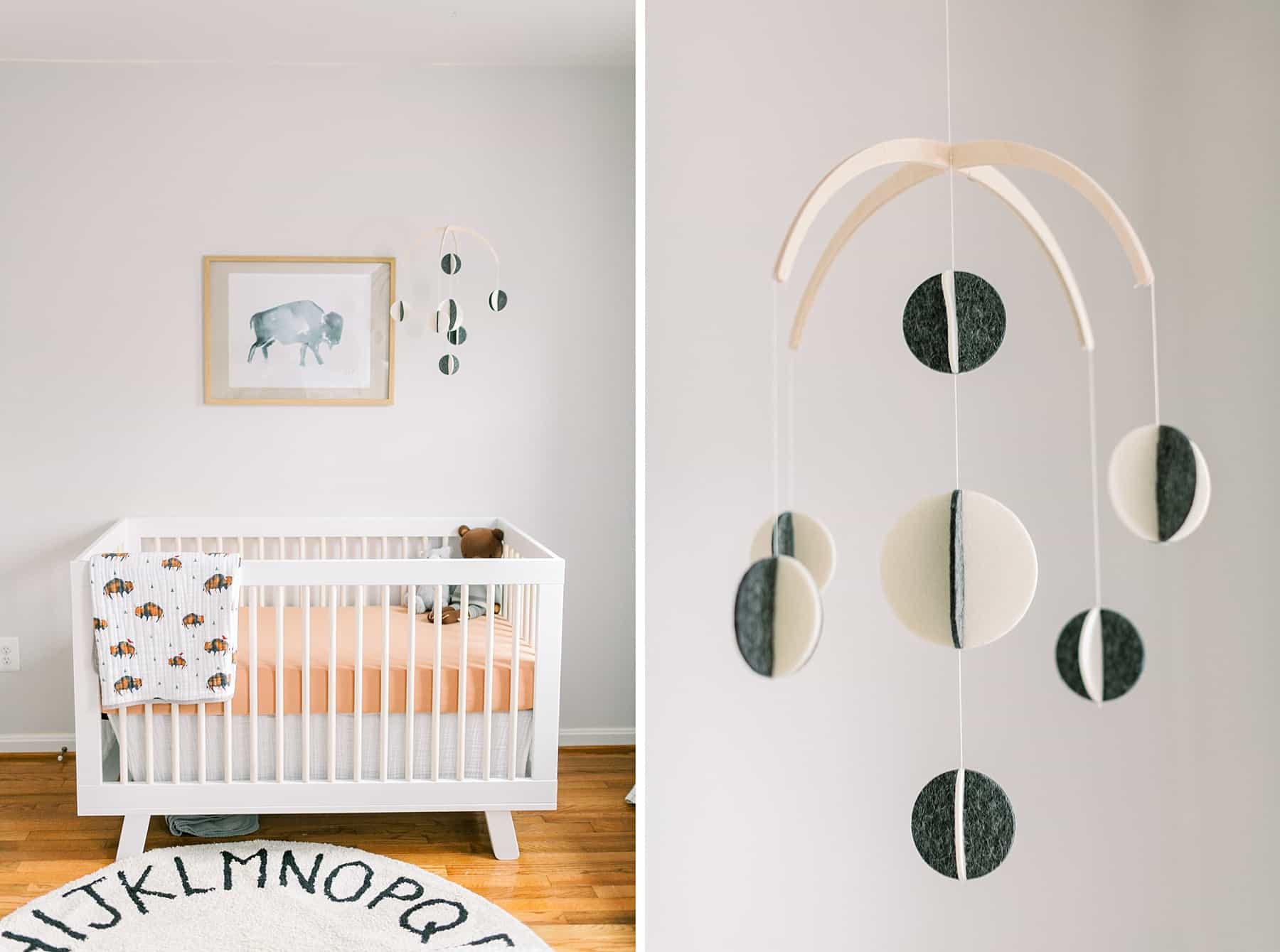 white crib with orange sheet and black and cream felt mobile in a Bison & Buffalo Inspired Nursery