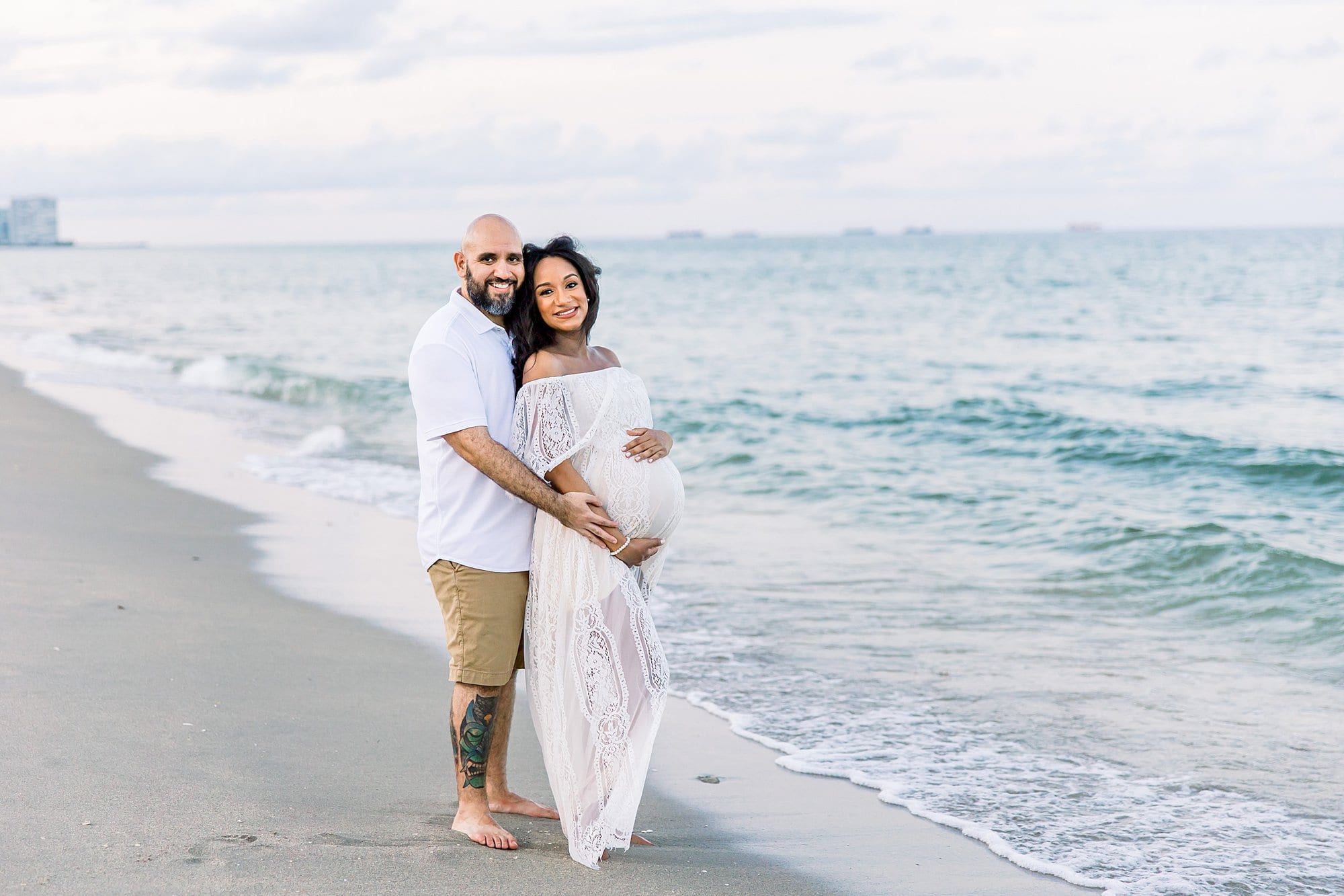 pregnant couple on the beach as an example of date night ideas in miami