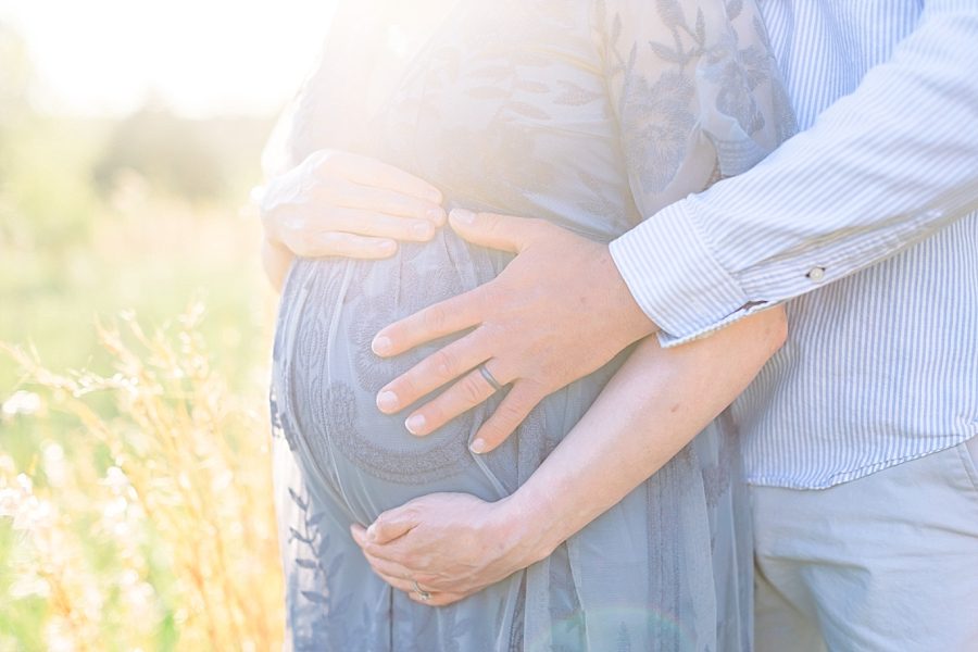 Detail image of baby bump during outdoor photo shoot