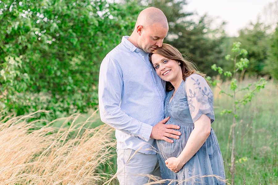 Snuggling couple during maternity photo session