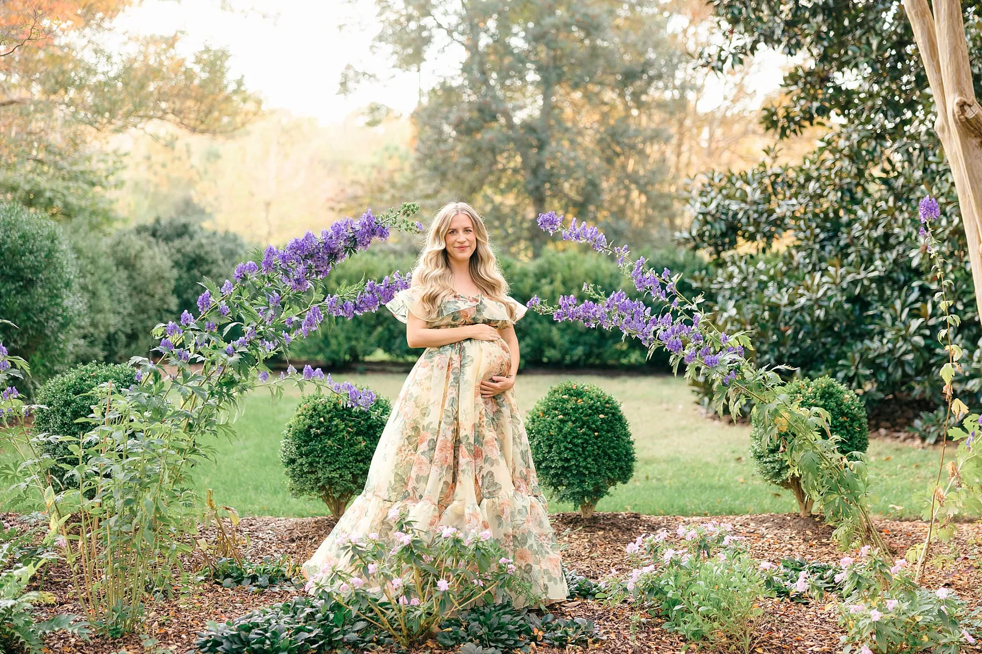 pregnant woman in floral dress in a garden