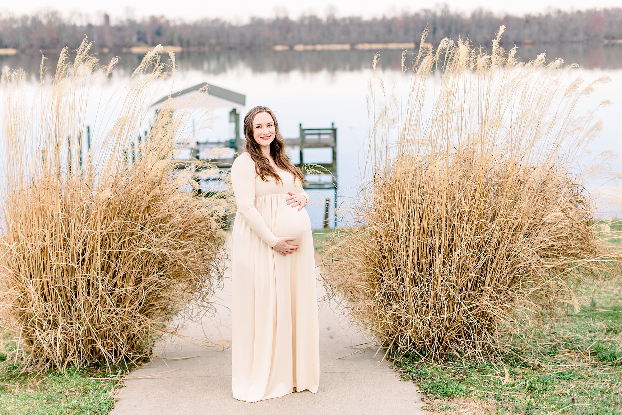 Winter outdoor session with mom in long dress by a river