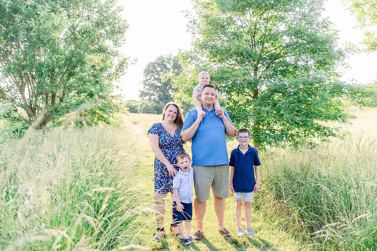 Why Motherhood Photography is So Important 1 a family of four together wearing blues