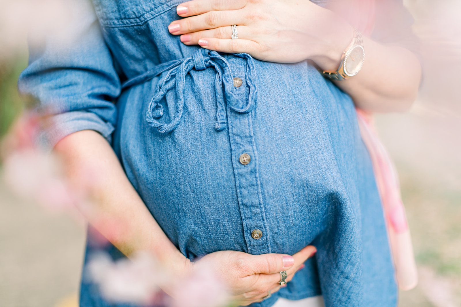 How a Richmond VA Fertility Clinic Can Help Your Pregnancy! 7 a close up of a a pregnant moms belly wearing a blue dress